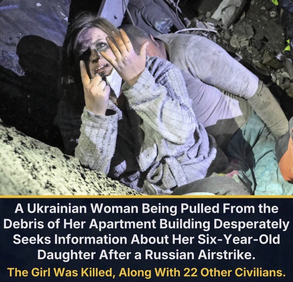 Yana, covered in dust and wearing a bathrobe, raises her hands as she is pulled from the rubble of her apartment building in Zaporizhzhia beside her husband, Anton.
